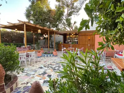 a patio with a table and chairs and a table and chairs at El Gezira Hotel in Luxor