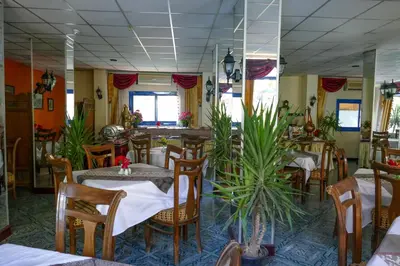 a restaurant with tables and chairs and plants at El Gezira Garden Hotel Luxor in Luxor
