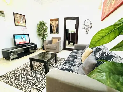 a living room with a couch and a tv at Elephant House with Sea View in Hurghada