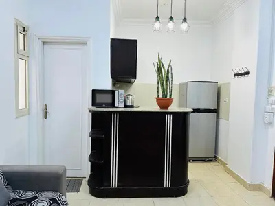 a kitchen with a counter with a microwave and a refrigerator at Elephant House with Sea View in Hurghada