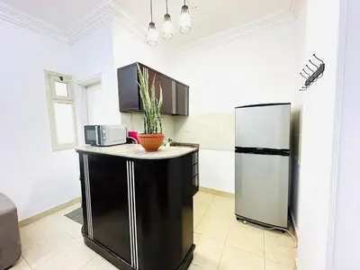 a kitchen with a counter and a refrigerator at Elephant House with Sea View in Hurghada