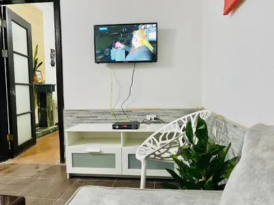 a living room with a tv on a wall at Zebra House Hurghada center in Hurghada