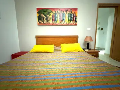 a bedroom with a bed with two yellow pillows at Jazz House Hurghada canter with WI FI in Hurghada