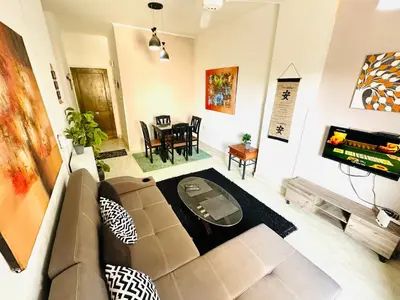 a living room with a couch and a tv at Jazz House Hurghada canter with WI FI in Hurghada