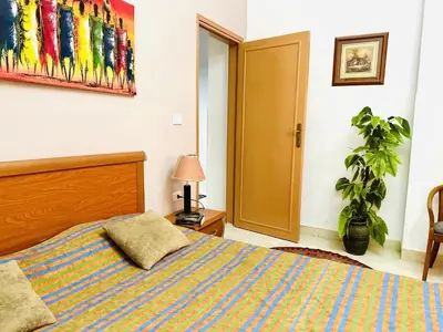 a bedroom with a bed and a plant in it at Jazz House Hurghada canter with WI FI in Hurghada