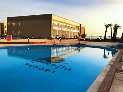a large swimming pool in front of a building at Chalet in Cecelia Resort in Hurghada