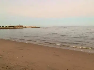 a beach with a body of water and the ocean at Chalet in Cecelia Resort in Hurghada