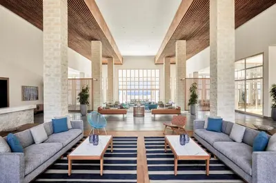 a lobby with couches and tables in a building at JAZ Elite Maraya in Coraya Bay