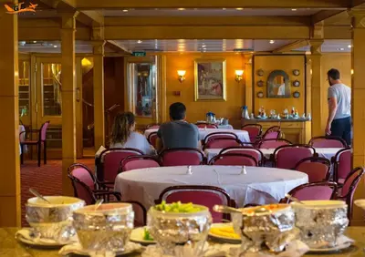 a group of people sitting at a table in a restaurant at Nile Cruise Luxor Aswan 3,4 and 7 nights in Aswan