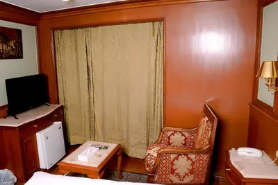 a room with a bed and a table and a chair at Nile Cruise Luxor Aswan 3,4 and 7 nights in Aswan