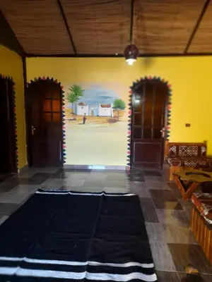 a room with two doors and a painting on the wall at Kindaka amany in Aswan
