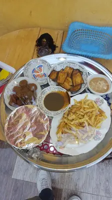 a tray of food on a table with plates of food at Kindaka amany in Aswan