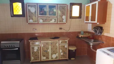 a kitchen with a counter and a sink in it at Kindaka amany in Aswan
