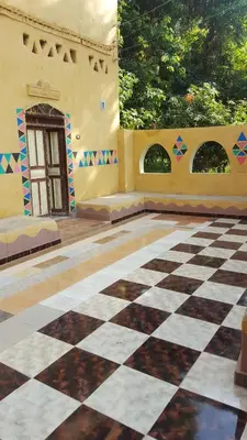 a room with a checkered floor and a building at Kindaka amany in Aswan