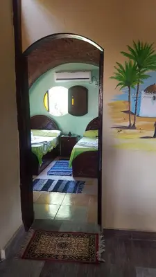 a mirror in a room with a bedroom with a bed at Kindaka amany in Aswan