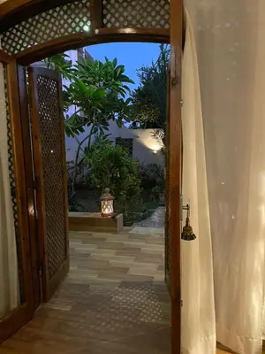 an open door to a house with a courtyard at Villa Quiet Place in Luxor