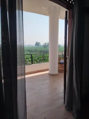 an open door to a balcony with a view at Villa Quiet Place in Luxor