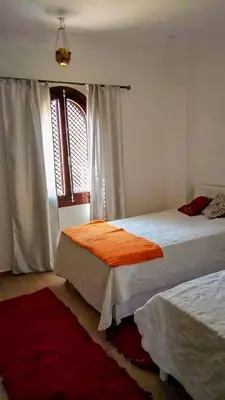 a bedroom with two beds and a window at Villa Quiet Place in Luxor
