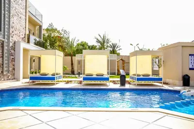 a swimming pool in front of a building at Serenity Home Hurghada in Hurghada