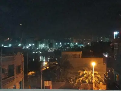 a night view of a city with lights at Adad Noubian House in Aswan