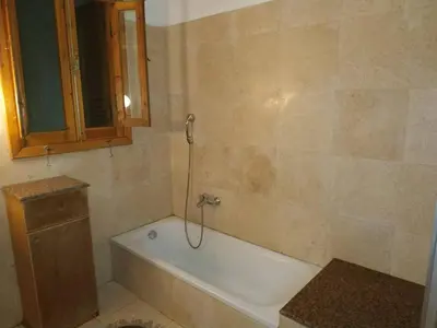 a bathroom with a bath tub and a sink at Adad Noubian House in Aswan