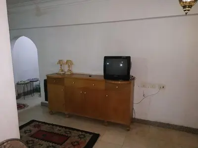 a tv sitting on top of a dresser in a room at Adad Noubian House in Aswan