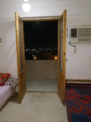 a room with a door open to a room with a window at Adad Noubian House in Aswan