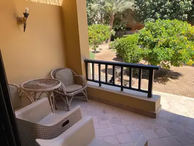 a balcony with a table and chairs and a table and chairs at El gouna South Marina Townhouse Apartment 3 bedrooms in Hurghada
