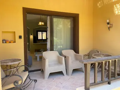 a patio with chairs and tables on a porch at El gouna South Marina Townhouse Apartment 3 bedrooms in Hurghada