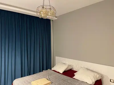 a bedroom with a bed with a blue curtain at El gouna South Marina Townhouse Apartment 3 bedrooms in Hurghada