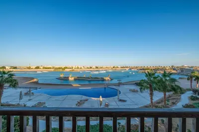 a view of the pool from the balcony of a resort at Luxury 3 Bedroom Apt. in El Gouna with amazing view in Hurghada
