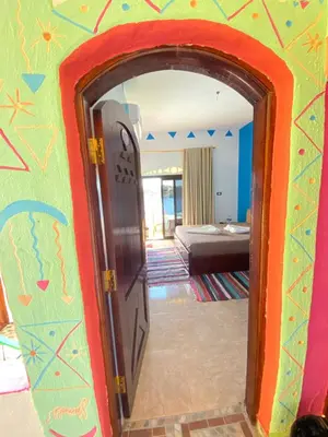 an open door into a room with a bedroom at Kendaka Nubian House in Aswan