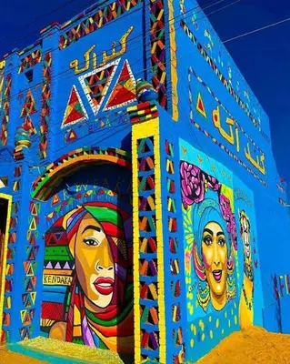 a building with a painting on the side of it at Kendaka Nubian House in Aswan