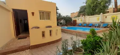 a villa with a swimming pool in a resort at Villa Bahri Luxor Apartment in Luxor