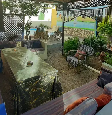 a patio with a swimming pool and a table with a table at Villa Bahri Luxor Apartment in Luxor