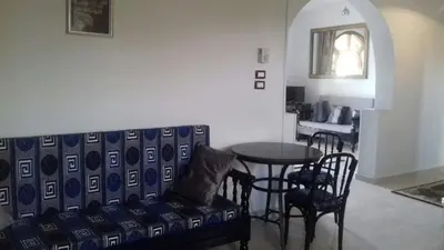 a living room with a couch and a table at Villa Bahri Luxor Apartment in Luxor