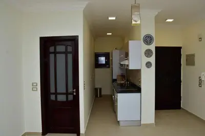 a kitchen with a door leading into a kitchen with a counter at The View El Quseir in Quseir