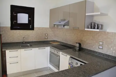 a kitchen with white cabinets and a sink at The View El Quseir in Quseir