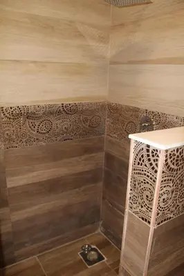 a bathroom with a shower with wooden walls at The View El Quseir in Quseir