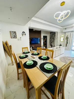 a dining room with a wooden table and chairs at Alis Villa in Hurghada