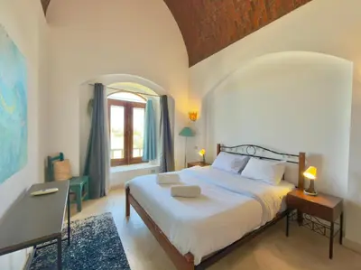 a bedroom with a large bed and a window at Lagoon view 1-bedroom apartment in West Golf El Gouna in Hurghada