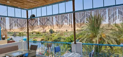 a view of a desert from a balcony with prayer flags at Basmatic Nubian Guest House in Aswan