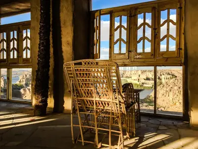 a wicker chair sitting in front of a window at Eco Nubia in Aswan