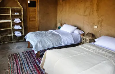 a bedroom with two beds and a room with two at Eco Nubia in Aswan