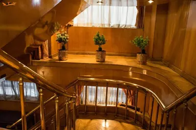 a spiral staircase with potted plants in a building at GTS Nile Cruise Luxor Aswan every monday from Luxor friday from Aswan in Luxor