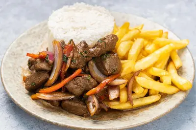 a plate of food with meat and french fries at Basma Executive Club in Aswan