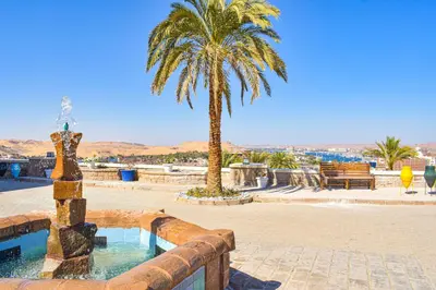 a palm tree and a fountain with a palm tree at Basma Executive Club in Aswan