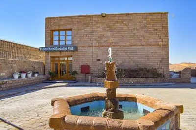 a fountain in front of a brick building at Basma Executive Club in Aswan