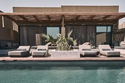 a group of lounge chairs next to a swimming pool at Casa Cook El Gouna - Adults Only in Hurghada