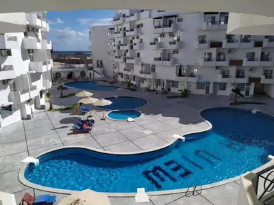 an overhead view of a swimming pool in front of a building at Studio 5min from ElGouna and Kite station in Hurghada